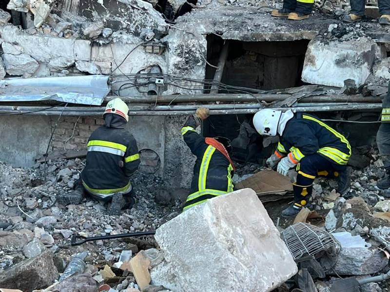 Rescuers searching the rubble of a destroyed apartment building in Borodianka, Ukraine